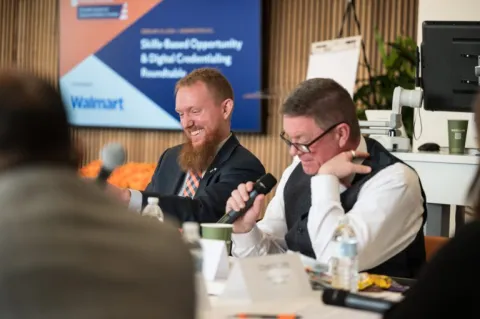 People laughing at the Walmart roundtable