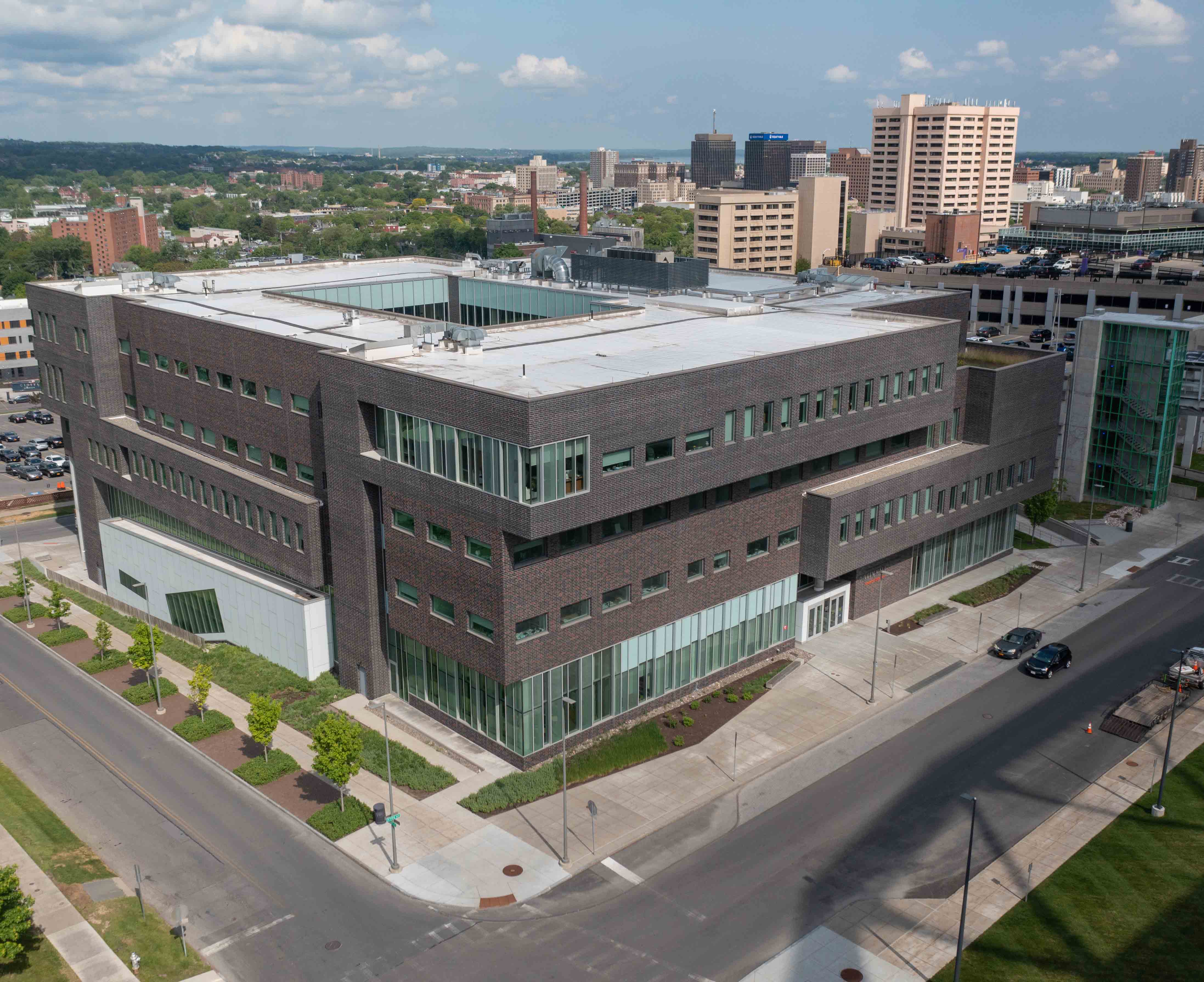 Aerial view of Dineen Hall, with the city of Syracuse in the background.