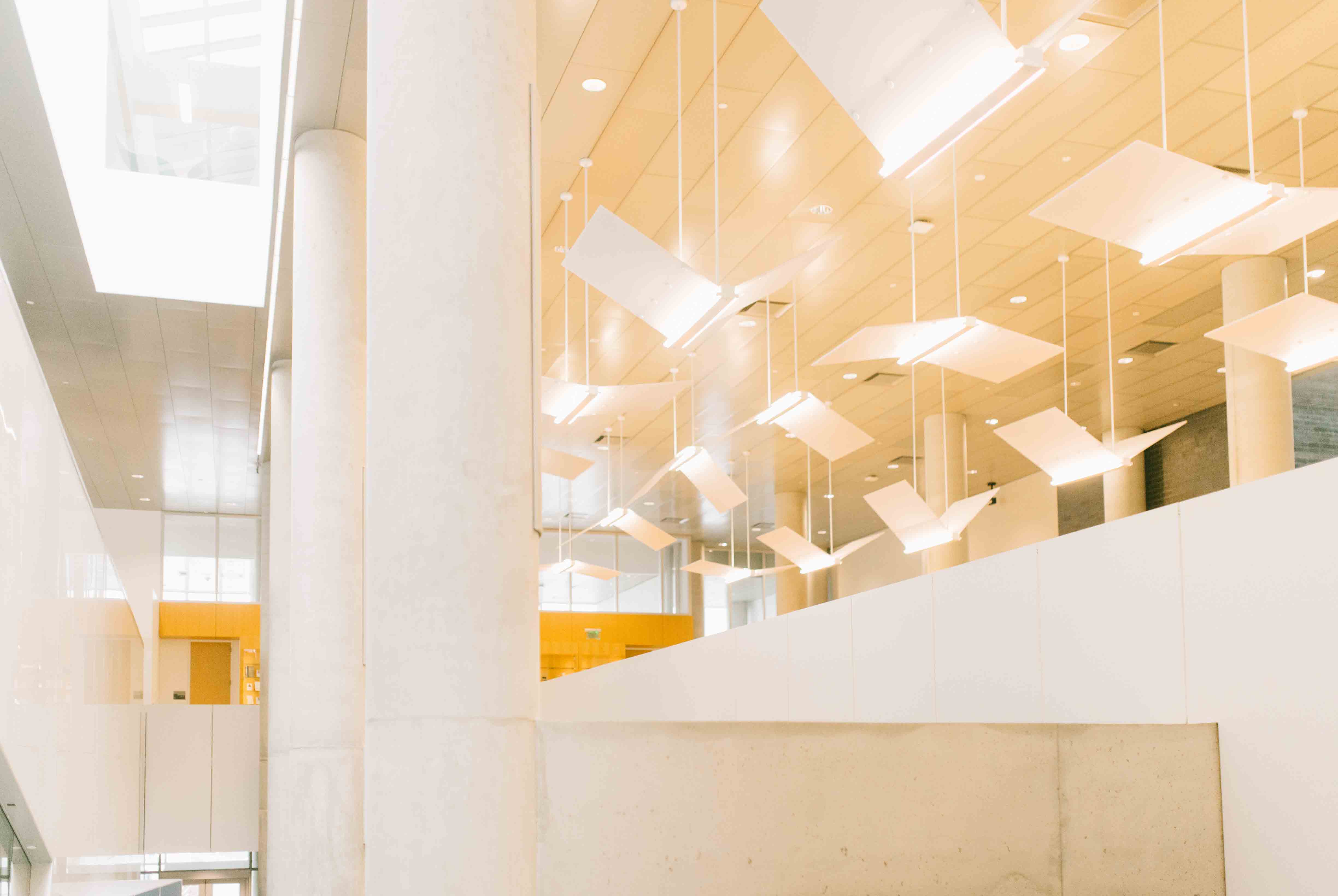 College of Law atrium, ceiling view with lights and columns, abstract.