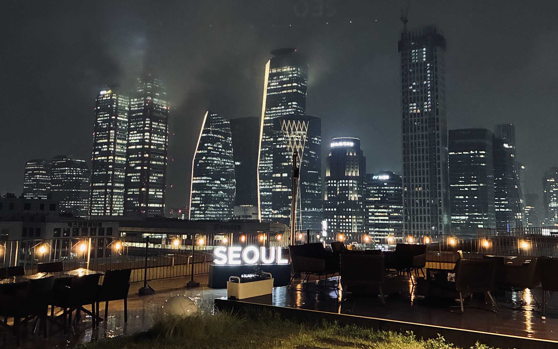 City of Seoul, South Korea at night with lit up buildings.