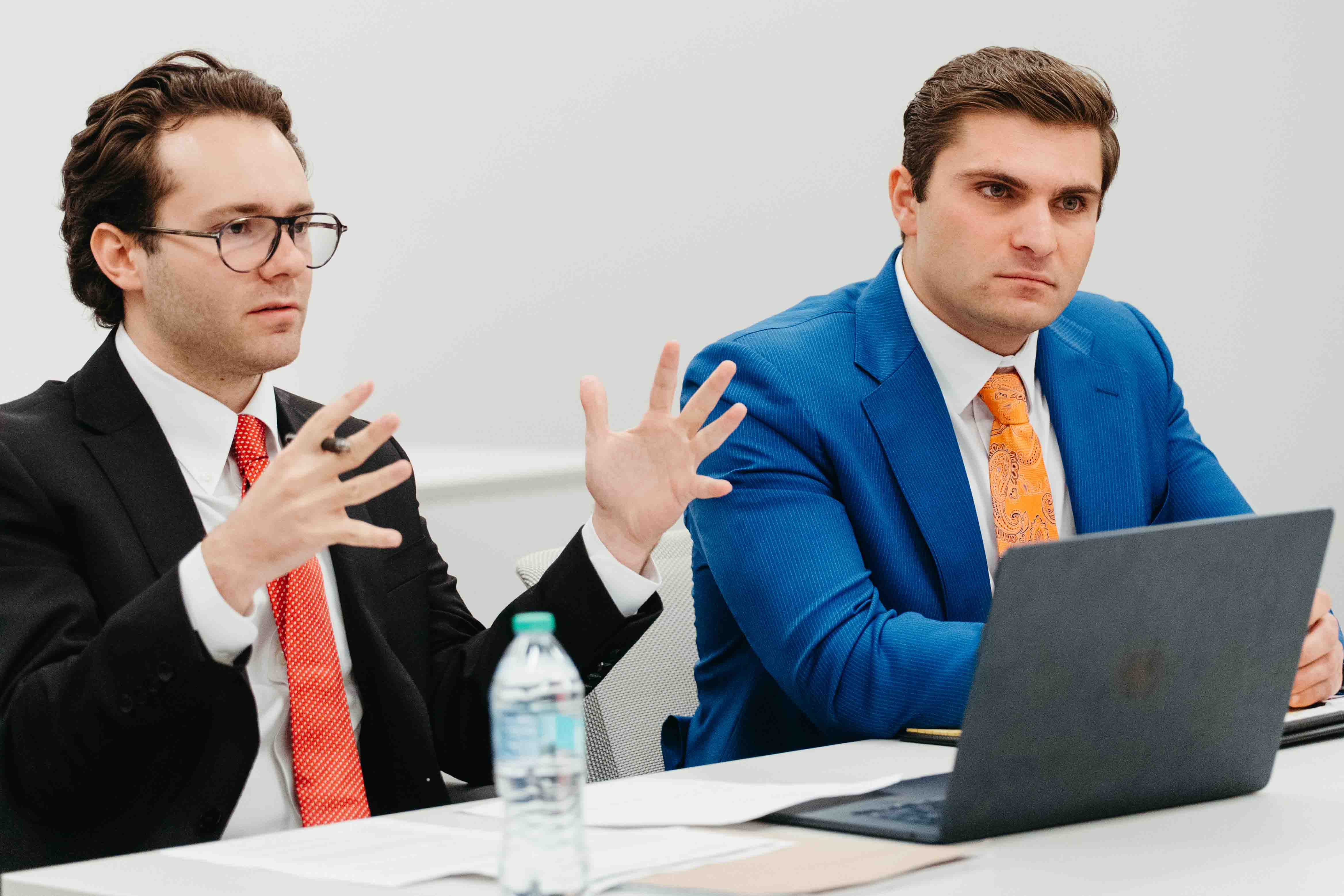 two students in suits argue a case at the NIL competition.
