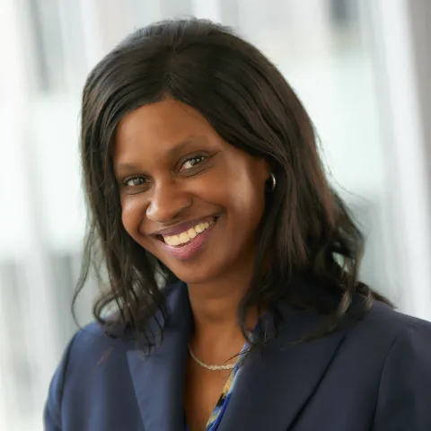 A woman with dark hair in a dark suit jacket.