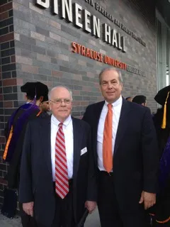 Mark Neporent and Bob Dineen stand in front of Dineen Hall.