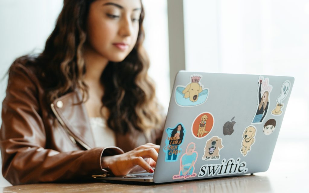 Maheen on her laptop adorned with many stickers