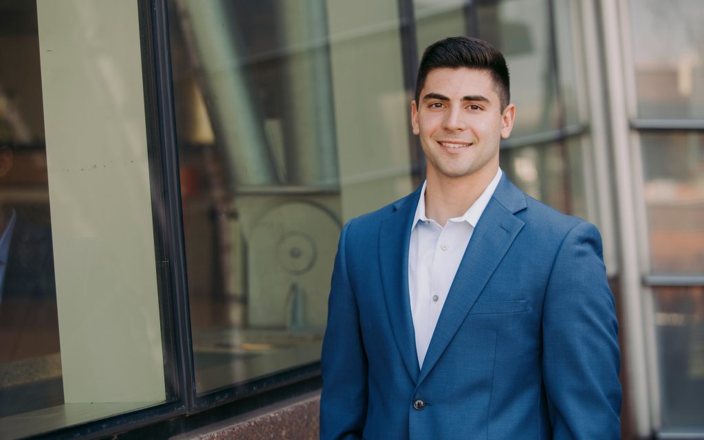 Chris Salotto standing in front of a glass wall