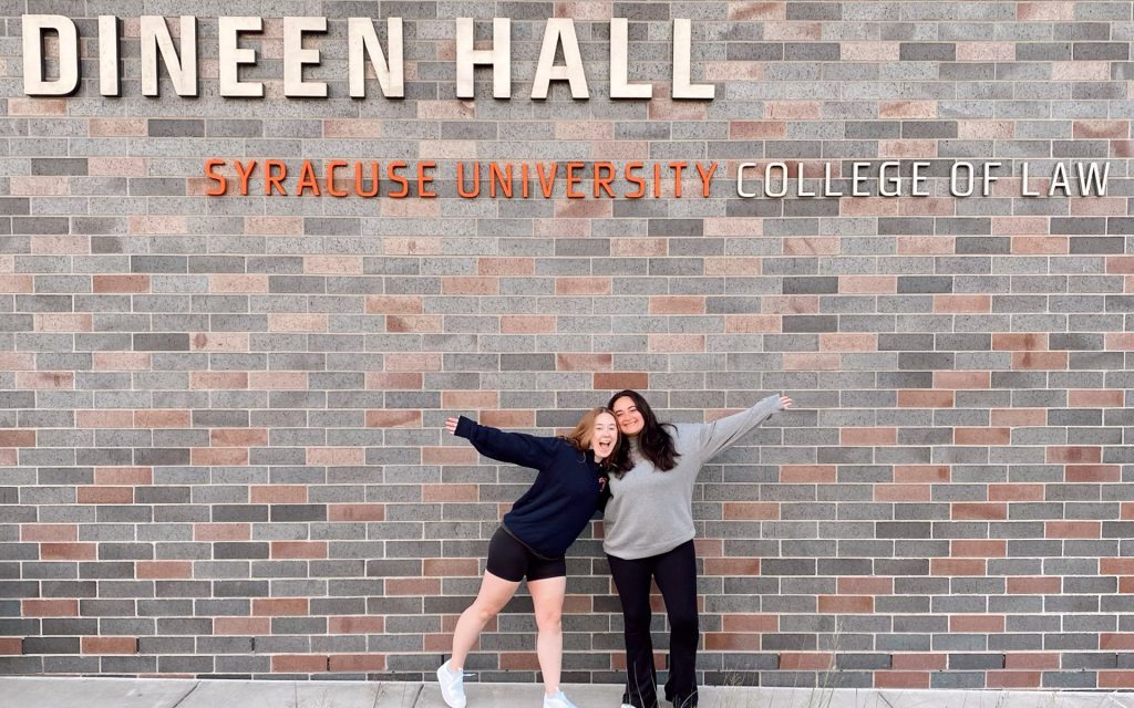Gilman poses with a friend outside of Dineen Hall