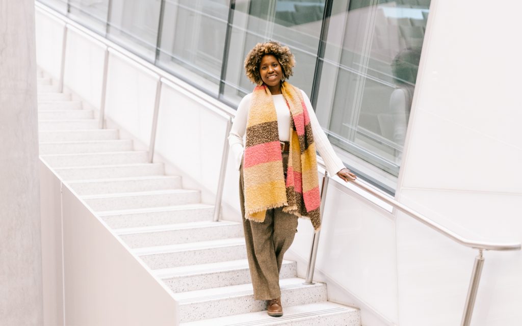 Yendi Fontenard L&rsquo;26 walking down the staircase in Dineen Hall