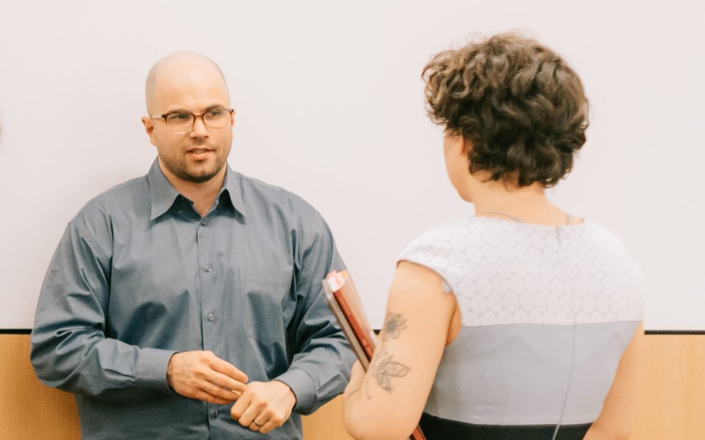 Creager chatting with a classmate during the January 2024 residency