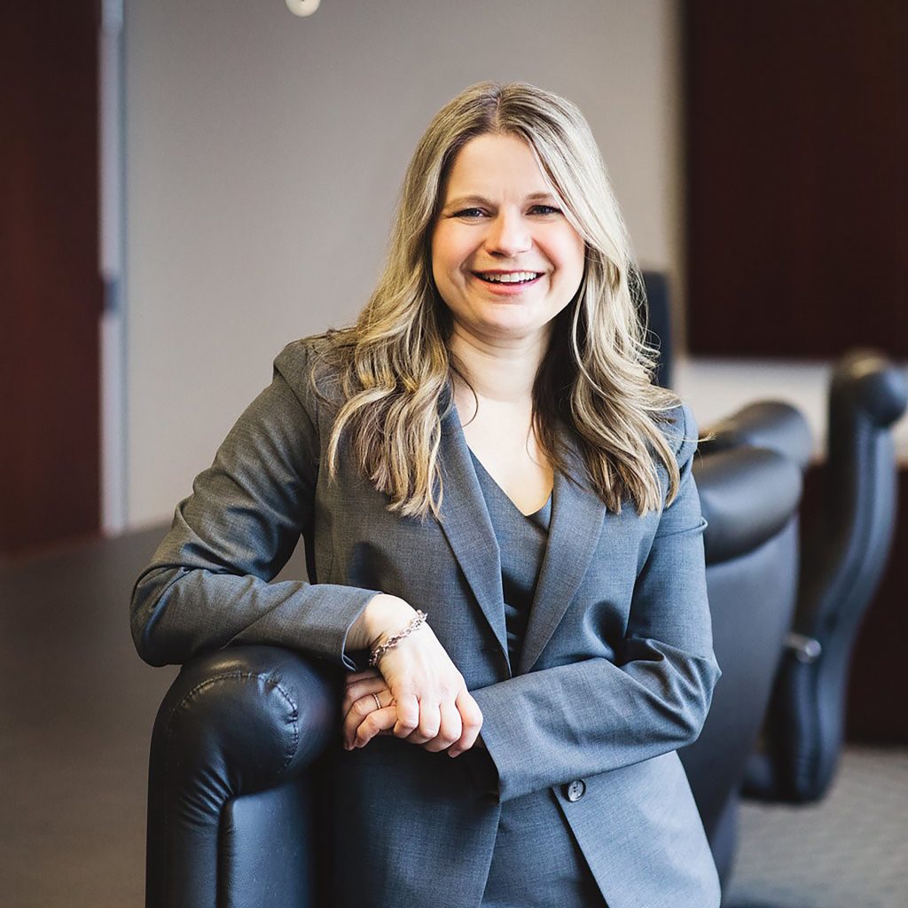 Kim Wolf Price Headshot wearing a gray suit