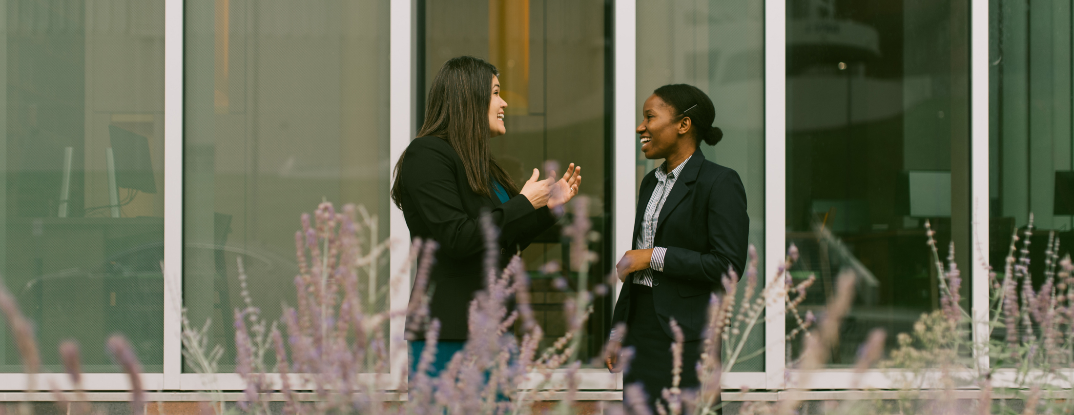 Two LL.M. students having a conversation in front of Dineen Hall.
