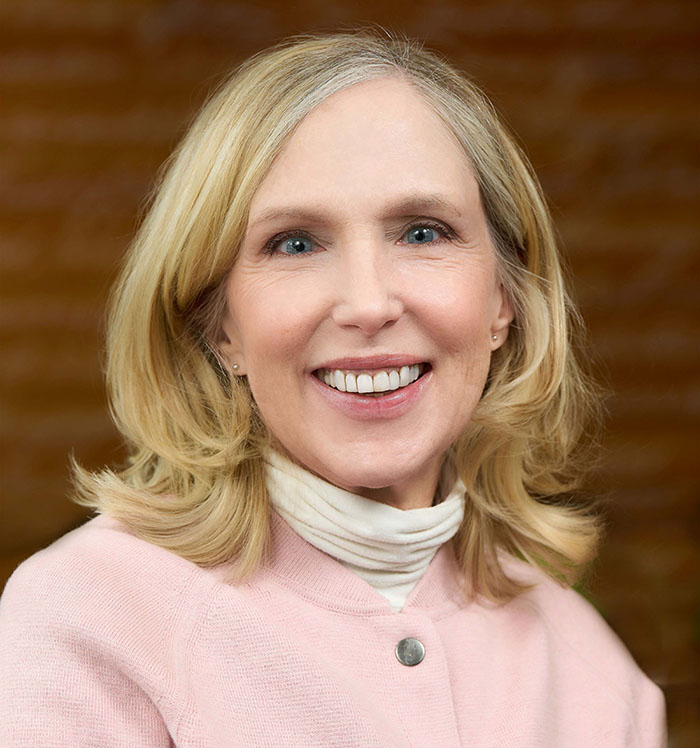 Portrait style photograph of Lisa Dolak smiling at the camera