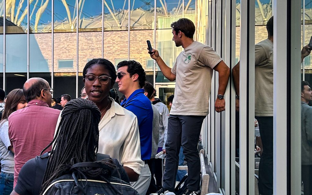 Noah taking a video with his phone during a Syracuse Bar Association Third Thursday Event on a beautiful sunny day