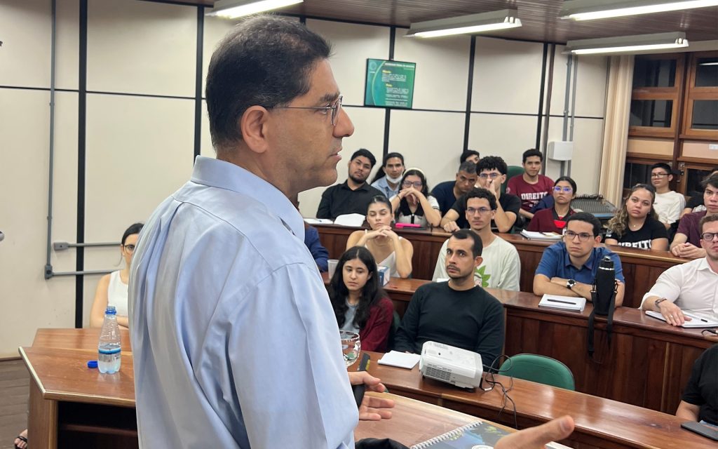 Professor Gidi teaching from the front of a classroom