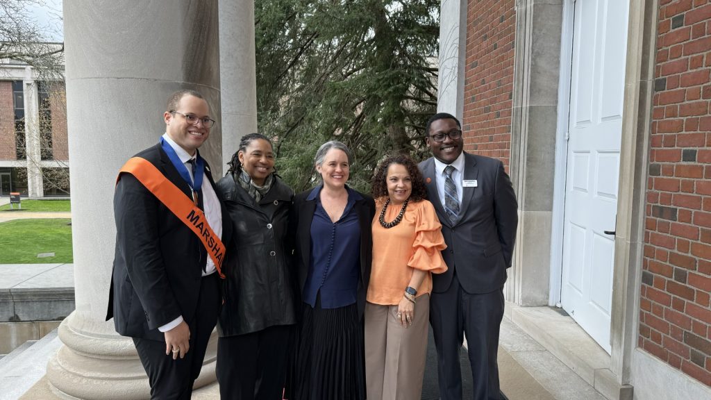 Suzette Melendez stands with a graduate of Syracuse Law and two other professors outside of a law school building