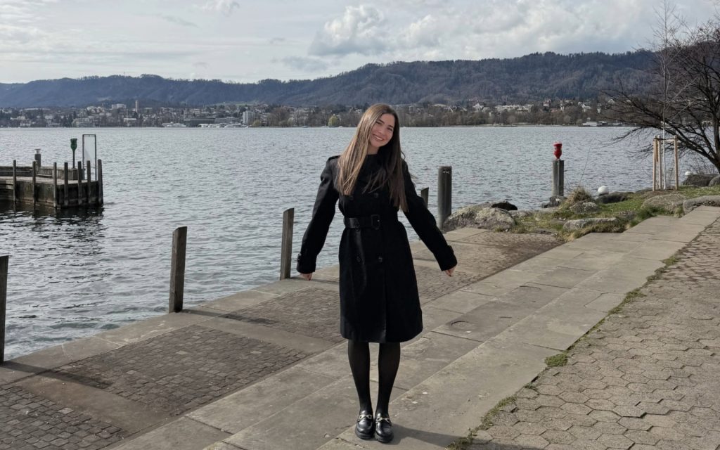 Syracuse Laws student standing in front of water and views in Switzerland