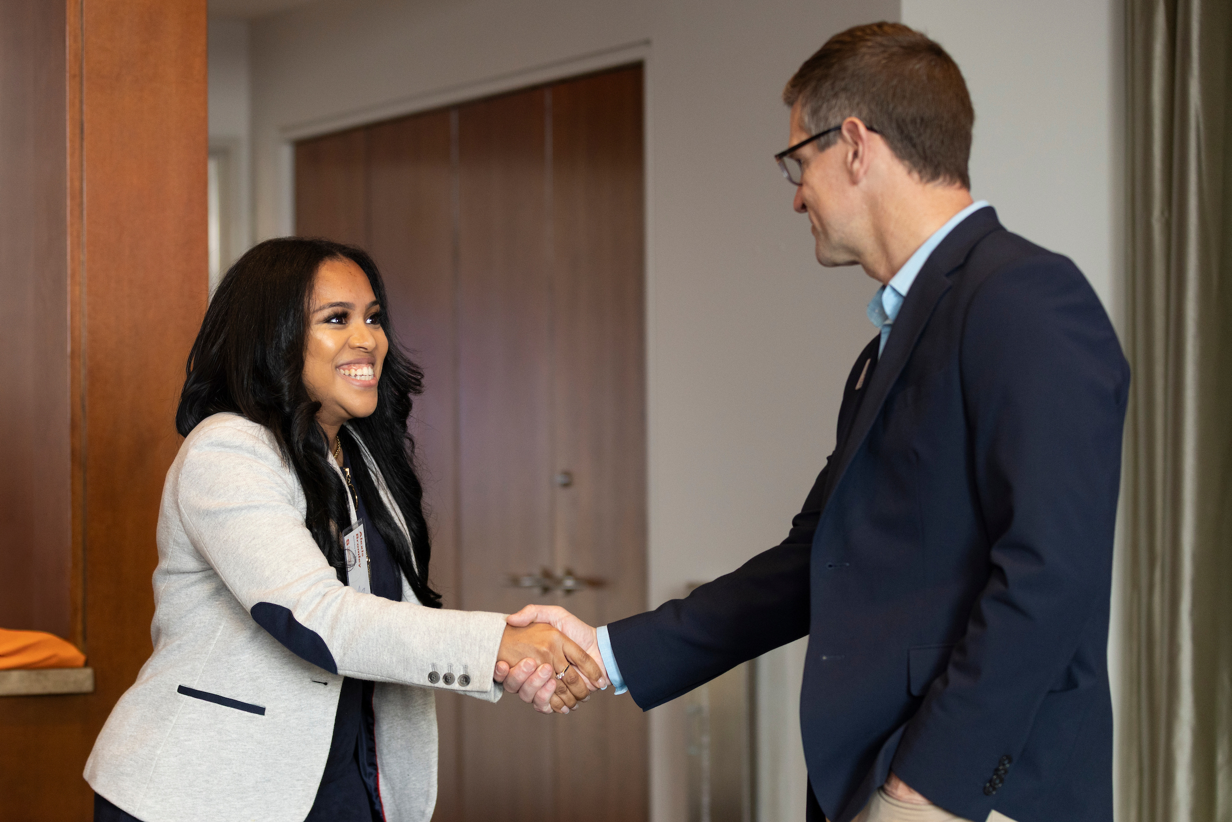 A female student shaking her professors hand at the Syracuse University Whitman School of Management. 