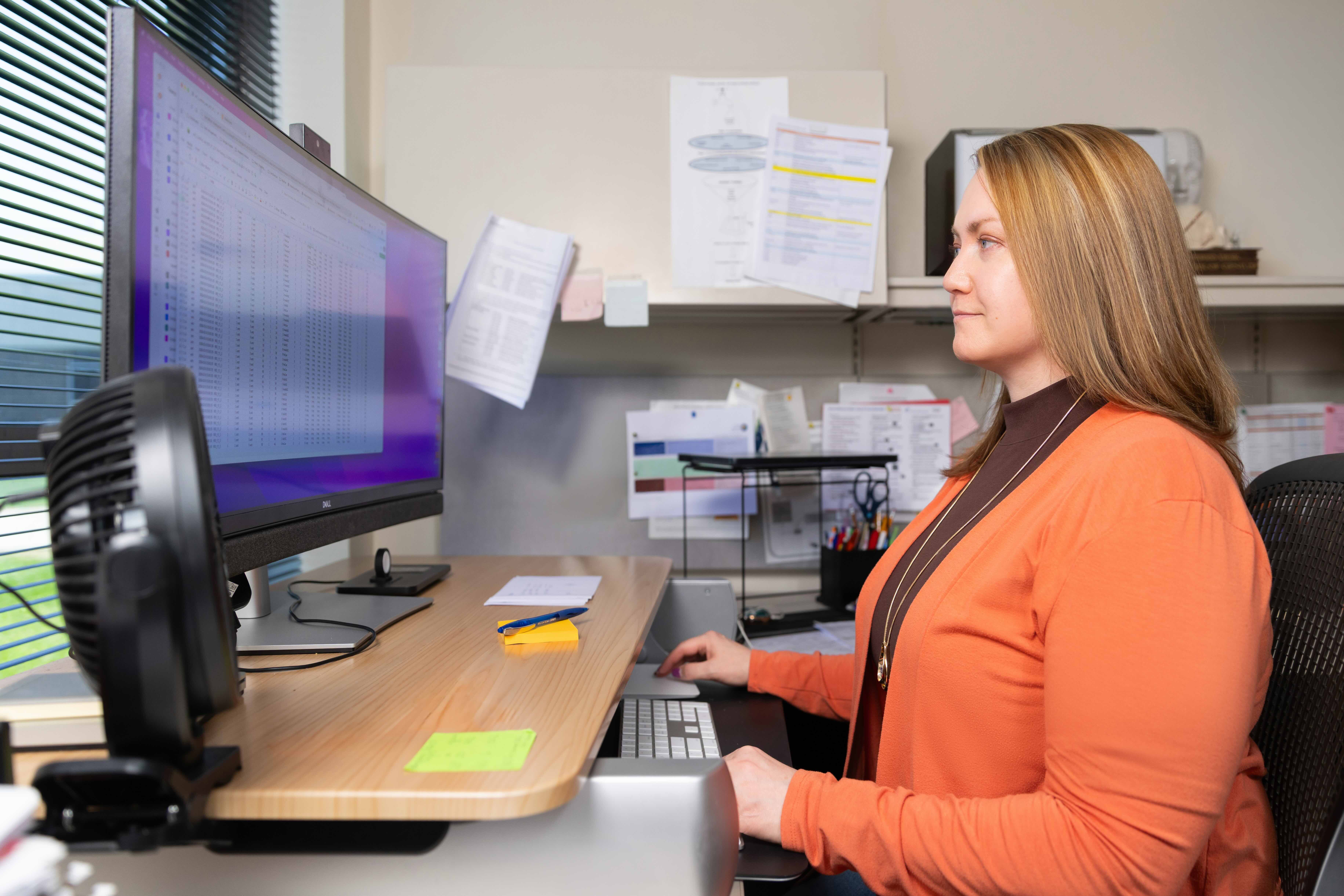 Dr. Ellyn Riley in front of a computer. 