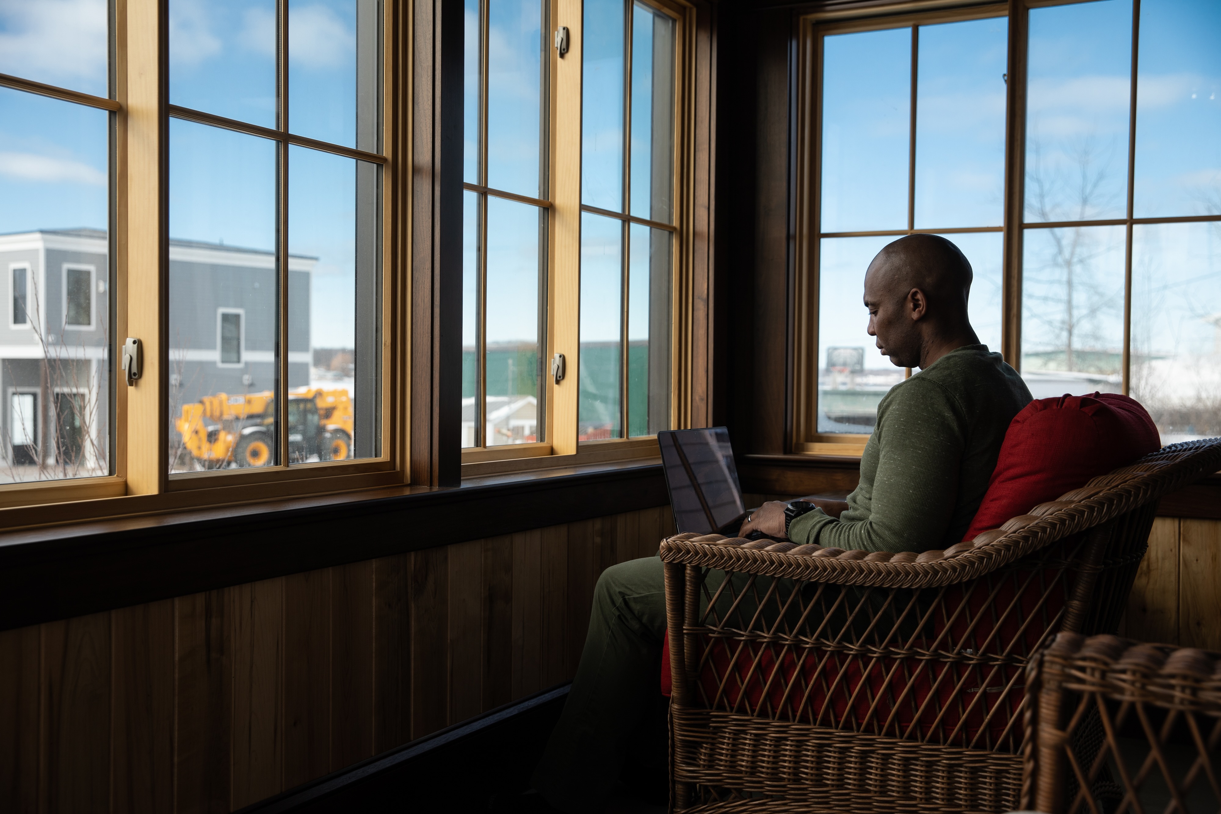 A person siting in a chair on the computer. 