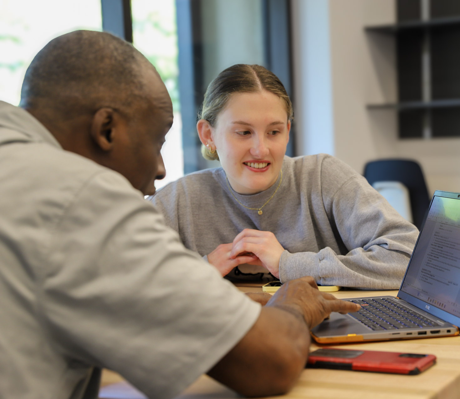 Man and woman working together on a laptop