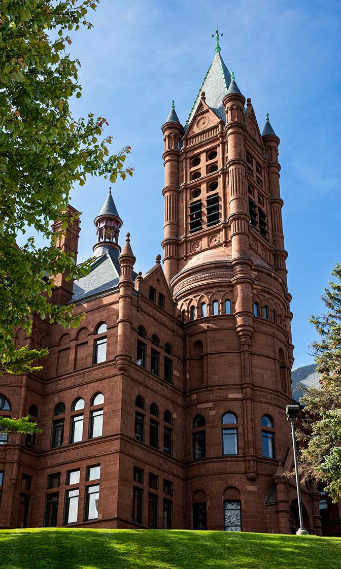 Crouse College on a sunny fall day, blue sky, green grass