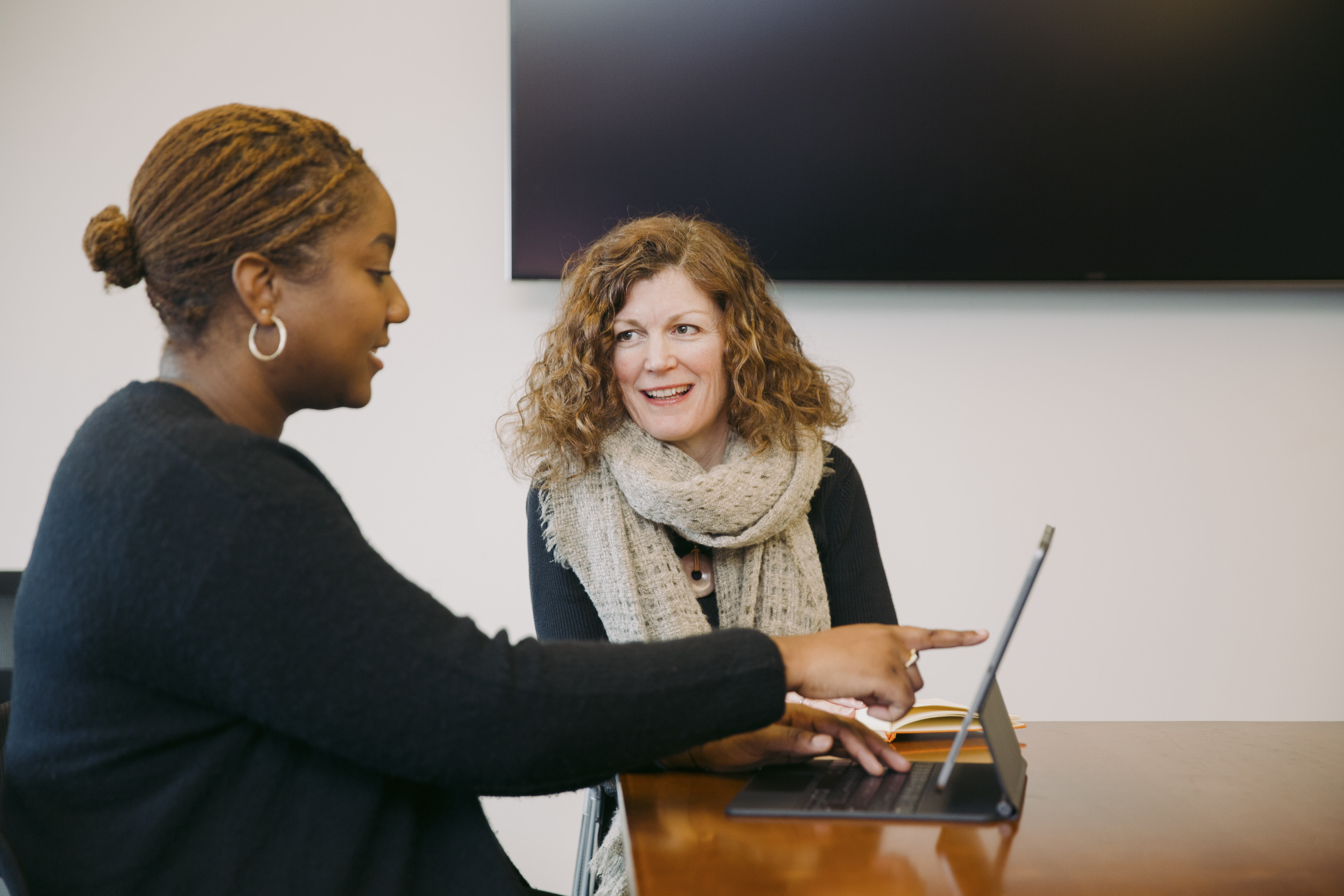 Two women working on a laptop