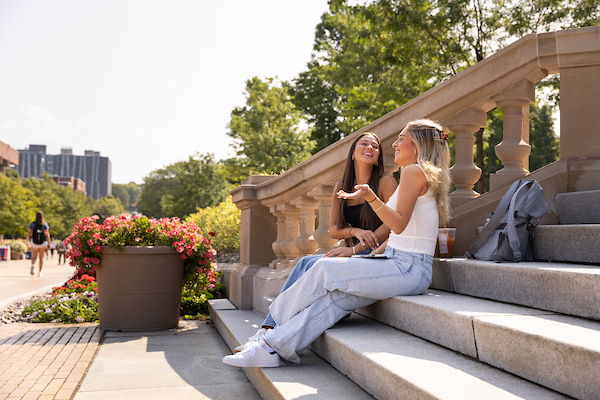 Two Female Syracuse Students Sitting on Steps
