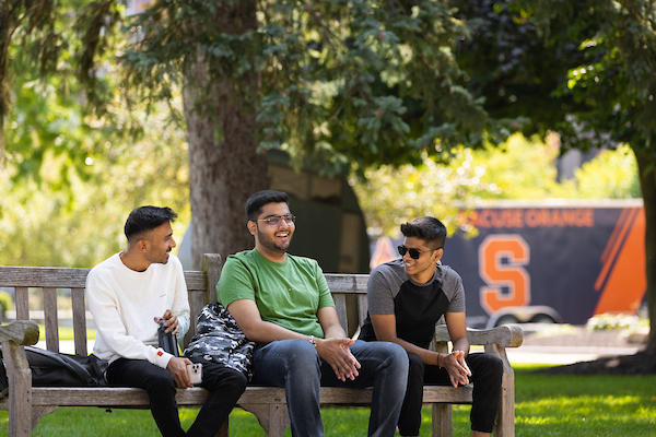 International Students sitting on a bench at Syracuse University
